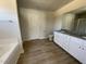 Spacious main bathroom featuring a double vanity, linen closet, and separate shower at 74 Harvest Hills Ln, Dunn, NC 28334