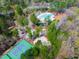 Community amenities viewed from above including tennis courts and pool surrounded by natural landscape at 7616 Valley Run Dr, Raleigh, NC 27615