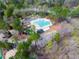 Aerial view of a community pool and recreation area, surrounded by lush greenery and trees at 7616 Valley Run Dr, Raleigh, NC 27615