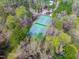 Overhead view showcasing tennis courts in a community surrounded by trees, perfect for recreational activities at 7616 Valley Run Dr, Raleigh, NC 27615