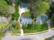 Aerial view showing the property nestled among trees with the house and driveway visible from above at 7616 Valley Run Dr, Raleigh, NC 27615