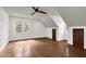 A bedroom space with hardwood floors, neutral walls, and a ceiling fan at 7616 Valley Run Dr, Raleigh, NC 27615