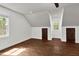 An empty bedroom with hardwood floors, neutral walls, and a ceiling fan at 7616 Valley Run Dr, Raleigh, NC 27615