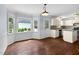 Bright dining area with hardwood floors and beautiful natural light streaming through the windows at 7616 Valley Run Dr, Raleigh, NC 27615