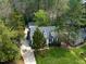 Aerial view of a charming two-story home with a well-maintained lawn and mature trees at 7616 Valley Run Dr, Raleigh, NC 27615