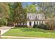 Charming home with white siding, black shutters, dormer windows, brick stairs, and a lush front lawn at 7616 Valley Run Dr, Raleigh, NC 27615