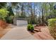 View of the two-car garage situated on a long driveway near a wooden deck with built-in benches at 7616 Valley Run Dr, Raleigh, NC 27615