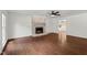 Open living room featuring a fireplace and hardwood floors, great for entertaining at 7616 Valley Run Dr, Raleigh, NC 27615