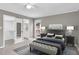 Stylishly furnished primary bedroom features a sitting bench and en-suite bath at 7616 Valley Run Dr, Raleigh, NC 27615