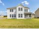 Spacious two-story white home with a screened in porch and ample backyard at 779 Old Station Pointe, Angier, NC 27501