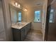Bathroom featuring a double sink vanity, a large mirror, and a glass enclosed shower at 779 Old Station Pointe, Angier, NC 27501