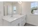 Well-lit bathroom features double vanity, large mirror, and a view outside at 779 Old Station Pointe, Angier, NC 27501