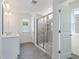Bright bathroom features double vanity, tiled shower with glass door and wood-look flooring at 779 Old Station Pointe, Angier, NC 27501