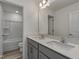 Bright bathroom featuring double sinks, gray cabinets, and a separate toilet and shower room at 779 Old Station Pointe, Angier, NC 27501
