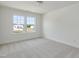 A light-filled bedroom with two large windows and neutral carpet at 779 Old Station Pointe, Angier, NC 27501
