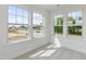 Sun-filled bedroom with three large windows and carpeted flooring at 779 Old Station Pointe, Angier, NC 27501