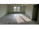 This bedroom features a large window and trey ceiling to brighten the space at 779 Old Station Pointe, Angier, NC 27501