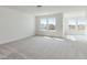 Large bonus room with plush carpeting, natural light, and neighborhood views at 779 Old Station Pointe, Angier, NC 27501