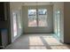 Bright dining area with access to backyard, large windows and a modern light fixture at 779 Old Station Pointe, Angier, NC 27501
