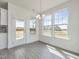 Bright dining area features a pendant light, access to the yard, and large windows at 779 Old Station Pointe, Angier, NC 27501