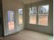 Sunlit dining area features windows and a door to backyard, plus a stylish light fixture at 779 Old Station Pointe, Angier, NC 27501