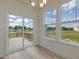 Bright dining room with sliding glass door to deck and multiple windows with scenic views at 779 Old Station Pointe, Angier, NC 27501
