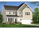Charming two-story home with a neutral facade, a two-car garage, and a landscaped front yard at 779 Old Station Pointe, Angier, NC 27501