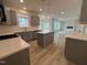 Open-concept kitchen with a center island and stainless steel appliances, creating a social atmosphere at 779 Old Station Pointe, Angier, NC 27501