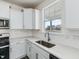 Bright kitchen featuring white cabinets, subway tile backsplash, and stainless steel sink at 779 Old Station Pointe, Angier, NC 27501