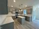 Kitchen with an island and grey cabinets at 779 Old Station Pointe, Angier, NC 27501
