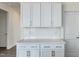 Bright kitchen with white cabinets, drawers, and stainless steel hardware at 779 Old Station Pointe, Angier, NC 27501