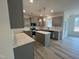 Modern kitchen with gray cabinets, stainless steel appliances, and a center island at 779 Old Station Pointe, Angier, NC 27501