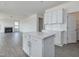 Open-concept kitchen with white island, cabinets, and view of the cozy living space at 779 Old Station Pointe, Angier, NC 27501