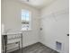 This laundry room offers a utility sink, window and shelving at 779 Old Station Pointe, Angier, NC 27501