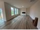 Open-concept living room with modern fireplace, large windows, and slider access to the outdoors at 779 Old Station Pointe, Angier, NC 27501
