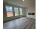 Spacious living room featuring a modern fireplace and large windows overlooking the yard at 779 Old Station Pointe, Angier, NC 27501