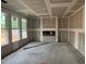A spacious living room features a modern fireplace and bright natural light from the windows at 779 Old Station Pointe, Angier, NC 27501