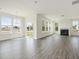 Spacious living room filled with natural light, featuring a fireplace, and wood-look flooring at 779 Old Station Pointe, Angier, NC 27501