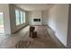 Bright living room with luxury vinyl plank flooring, fireplace, and large windows providing an abundance of natural light at 779 Old Station Pointe, Angier, NC 27501