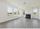 Bright living room with fireplace, large windows, and neutral color scheme at 779 Old Station Pointe, Angier, NC 27501
