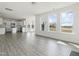 Open-concept living space featuring wood-look floors, natural light, kitchen, and dining area at 779 Old Station Pointe, Angier, NC 27501