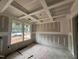 Under-construction living room with beautiful coffered ceilings, trimwork and natural light at 779 Old Station Pointe, Angier, NC 27501