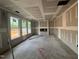 Spacious living room with under-construction trimwork, fireplace and natural light at 779 Old Station Pointe, Angier, NC 27501
