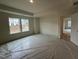 Unfurnished main bedroom with trey ceilings, large windows, and an open doorway to the en suite at 779 Old Station Pointe, Angier, NC 27501