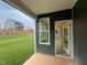 View of the patio with green lawn and dark blue siding and white trim at 779 Old Station Pointe, Angier, NC 27501