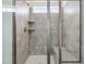 Tiled shower with glass door, built-in shelf, and seating at 779 Old Station Pointe, Angier, NC 27501