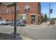 Street view showcasing a brick building with storefronts and parked vehicles along the roadside at 779 Old Station Pointe, Angier, NC 27501
