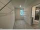 Walk-in closet with wire shelving units, window, and carpeted floor at 779 Old Station Pointe, Angier, NC 27501