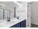 Modern bathroom featuring a double sink vanity with blue cabinets, and glass shower doors at 812 East St, Smithfield, NC 27577