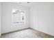 Bright bedroom features a large window offering natural light and neutral carpeting at 812 East St, Smithfield, NC 27577